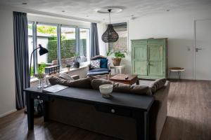 a living room with a couch and a table at Reseda apartment in Alblasserdam
