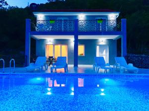 a villa with a swimming pool at night at Vila Wolf Montenegro in Budva