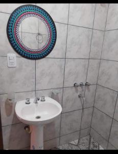 a bathroom with a sink and a mirror at Hostal Mary in Iruya