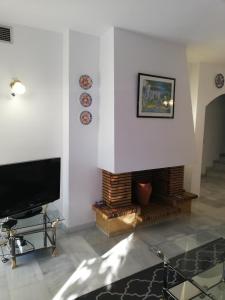 a living room with a fireplace and a flat screen tv at Apartament - dom, Hiszpania Andaluzja, Costa del Sol in Estepona