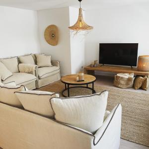 a living room with couches and a flat screen tv at Dune Du Clémot in Blankenberge