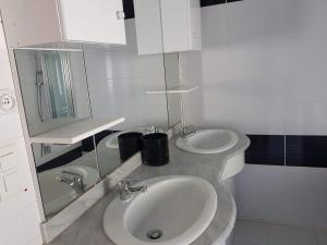 a white bathroom with two sinks and a mirror at Chambres d'hôtes Natacha et Franck in Labastide-Rouairoux +18 photos