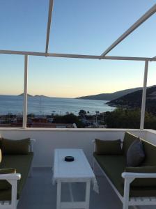 a living room with a view of the ocean at Old Kalamaki Pansiyon in Kalkan