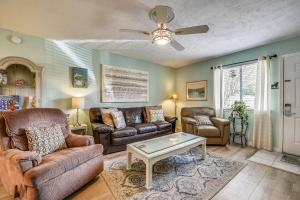 a living room with two couches and a table at 5 O'Clock Somewhere by Book That Condo in Panama City Beach