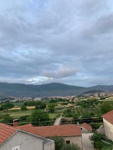 a view of a town with mountains in the distance at Apartman Bojanić in Trebinje