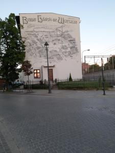 a building with a large mural on the side of it at Hostel Tip Top in Gdańsk
