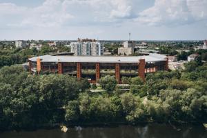 a large building with a roof in a city at Apart Lux Loft Panorama in Sumy