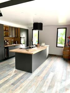 a kitchen with a large island in the middle at Maison le Pré de Paul in Saint-Savin