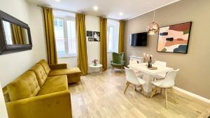 a living room with a couch and a table at Hedone Luxury 3 Apartments with FREE PARKING in Pula +40 photos