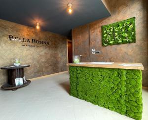 a room with a green wall with a counter and a sign at Relais Bella Rosina Pool & Spa in Fiano