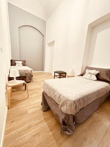 sypialnia z 2 łóżkami i krzesłem w obiekcie Casa Mole w Turynie