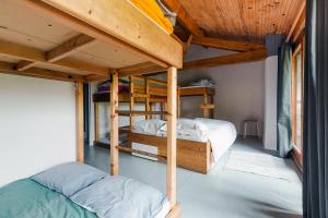 a bedroom with two bunk beds in a house at Gite Tilia in Huos