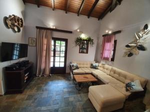 a living room with a couch and a table at VILLA GEORGIA in Acharavi