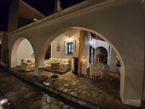 a living room with an archway and couches at VILLA GEORGIA in Acharavi