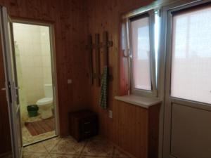a bathroom with a toilet and a window at Білий лебідь in Pulemets +116 photos