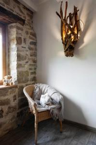 a room with a chair with a stuffed animal on it at La Belle Rivière in Bolozon