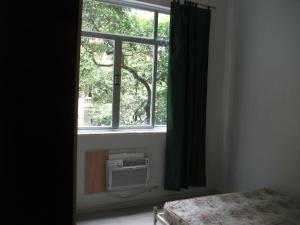 a bedroom with a window with a air conditioner at Apartamento Barata Ribeiro in Rio de Janeiro