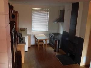a small kitchen with a table and a small table and a window at Pirtis Prie Neries Jonava in Jonava