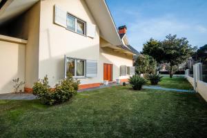 a house with a green yard next to a house at Villa in Esposende in Esposende