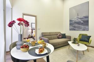 a living room with a table with food on it at D&A Central Luxury Apartments with FREE Parking in Pula