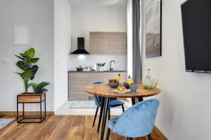 a kitchen and dining room with a table and chairs at D&A Central Luxury Apartments with FREE Parking in Pula