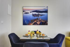 a table with two plates of food on it at D&A Central Luxury Apartments with FREE Parking in Pula