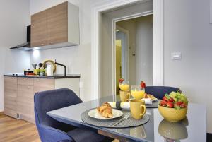 a dining room with a table with food on it at D&A Central Luxury Apartments with FREE Parking in Pula