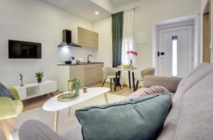 a living room with a couch and a table at D&A Central Luxury Apartments with FREE Parking in Pula