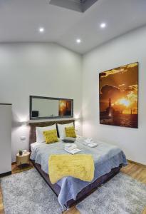 a bedroom with a bed with a large painting on the wall at D&A Central Luxury Apartments with FREE Parking in Pula