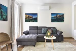 a living room with a couch and a table at D&A Central Luxury Apartments with FREE Parking in Pula