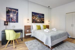 a bedroom with a bed and a desk and a chair at D&A Central Luxury Apartments with FREE Parking in Pula