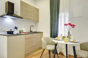 a small kitchen with a table and chairs in a room at D&A Central Luxury Apartments with FREE Parking in Pula