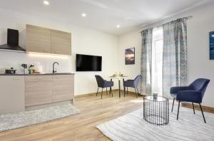 a kitchen and living room with a table and chairs at D&A Central Luxury Apartments with FREE Parking in Pula