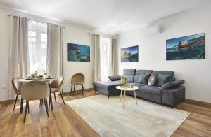 a living room with a couch and a table at D&A Central Luxury Apartments with FREE Parking in Pula