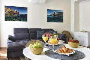 a living room with a table with food and drinks at D&A Central Luxury Apartments with FREE Parking in Pula