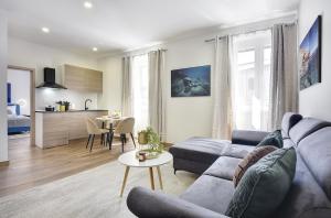 a living room with a couch and a table at D&A Central Luxury Apartments with FREE Parking in Pula