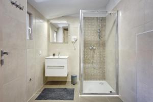 a bathroom with a shower and a toilet and a sink at D&A Central Luxury Apartments with FREE Parking in Pula