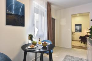 a living room with a table with food on it at D&A Central Luxury Apartments with FREE Parking in Pula