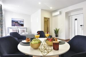a living room with a table with fruit on it at D&A Central Luxury Apartments with FREE Parking in Pula