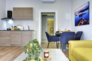 a living room with a yellow couch and a table at D&A Central Luxury Apartments with FREE Parking in Pula