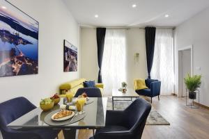 a living room with a table and chairs at D&A Central Luxury Apartments with FREE Parking in Pula