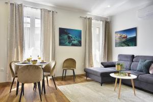 a living room with a couch and a table at D&A Central Luxury Apartments with FREE Parking in Pula