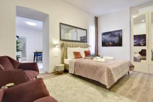 a bedroom with a bed and a couch and a chair at D&A Central Luxury Apartments with FREE Parking in Pula