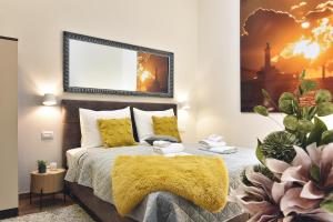 a bedroom with a bed with a yellow blanket at D&A Central Luxury Apartments with FREE Parking in Pula