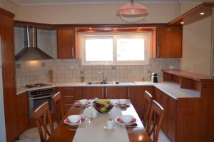 a kitchen with a table with a bowl of fruit on it at Elatia Villa in Volímai