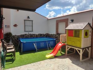 a play area with a slide and a play table at Casa Rural & SPA Mirador Gredos in Guijo de Ávila