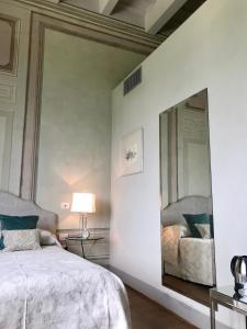 - une chambre avec un grand miroir et un lit dans l'établissement Country B&B Corniola, à Empoli