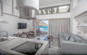 a living room with a couch and a table at Nama Sea Side Suites in Pláka