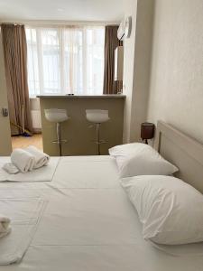 a bedroom with a large white bed with two pillows at Liberty Apartment in Tbilisi City