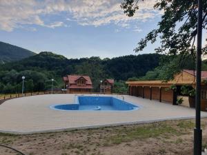 a large swimming pool in the middle of a yard at Lisine smeštaj Vodopad in Strmosten